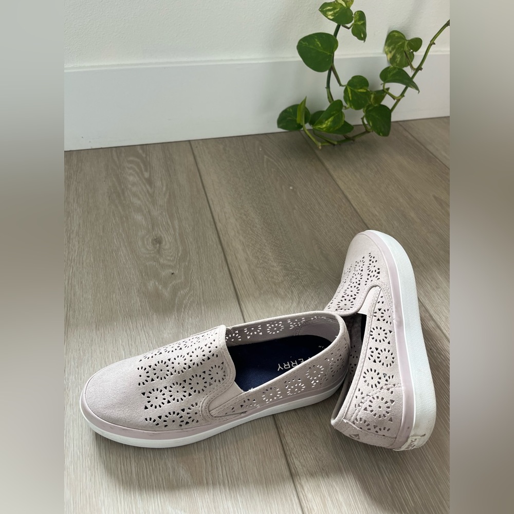 Sperry suede light pink slip-on boat shoes with floral cutout design.